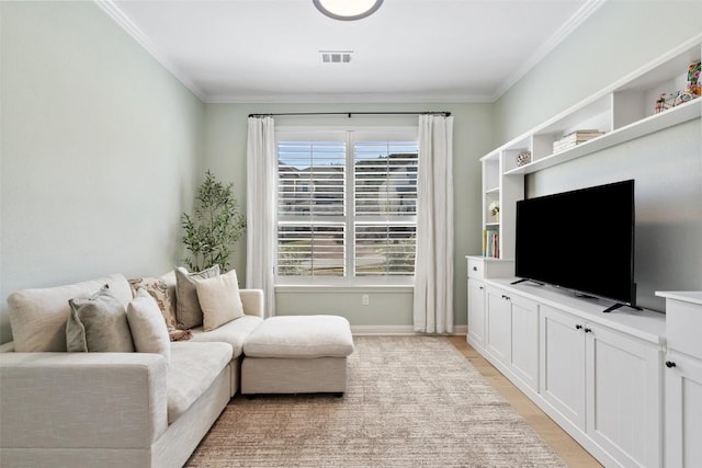 living area featuring ornamental molding, visible vents, light wood-style floors, and baseboards