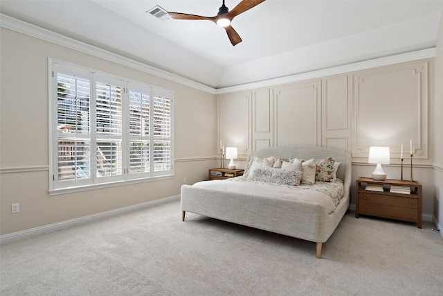 bedroom with baseboards, visible vents, a ceiling fan, light colored carpet, and crown molding