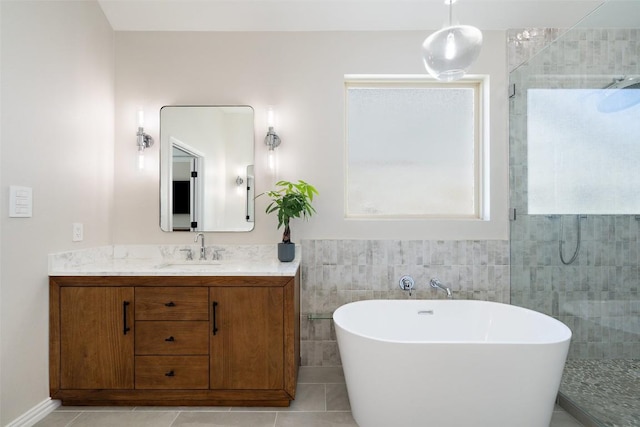 full bath featuring tiled shower, a freestanding tub, and tile patterned floors