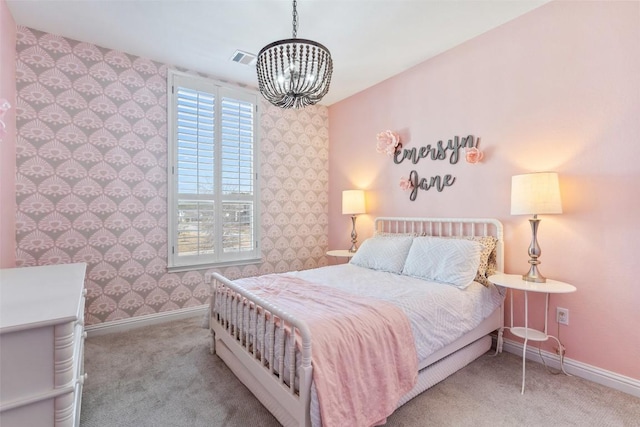 carpeted bedroom with wallpapered walls, baseboards, visible vents, and a chandelier