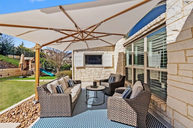 view of patio / terrace with a playground and an outdoor living space