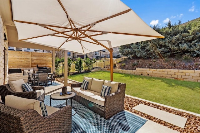 view of patio featuring outdoor dining space, a fenced backyard, and an outdoor living space