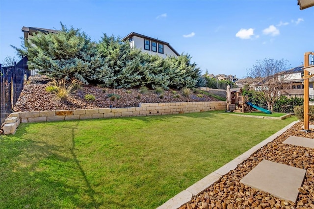 view of yard featuring a playground and fence