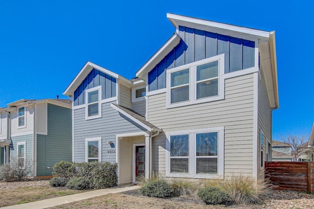 view of front of home with fence and board and batten siding