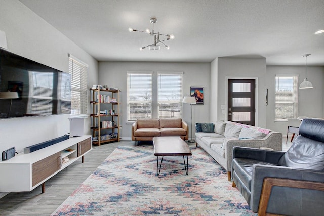 living area featuring a chandelier and wood finished floors