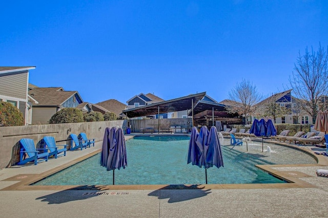 community pool featuring a patio area and fence