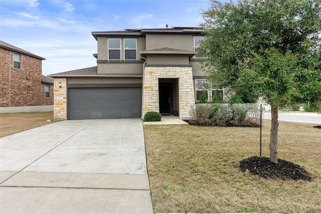 prairie-style home with a garage, concrete driveway, stone siding, stucco siding, and a front lawn