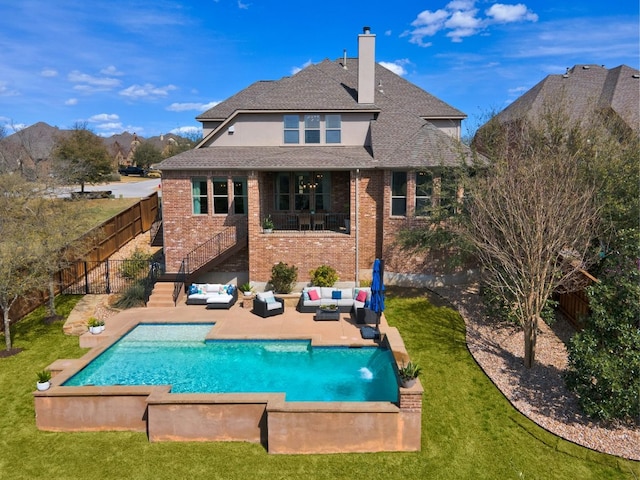 rear view of property featuring a patio, a lawn, stairway, a fenced backyard, and an outdoor living space