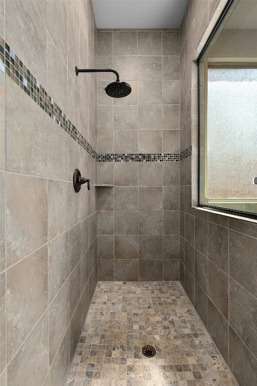 bathroom with a tile shower