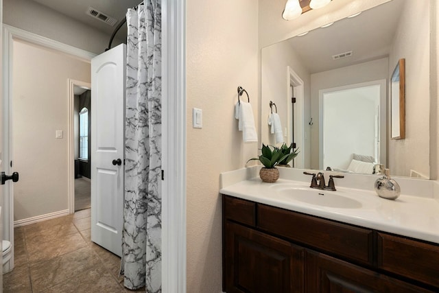 full bathroom with tile patterned flooring, visible vents, vanity, and baseboards