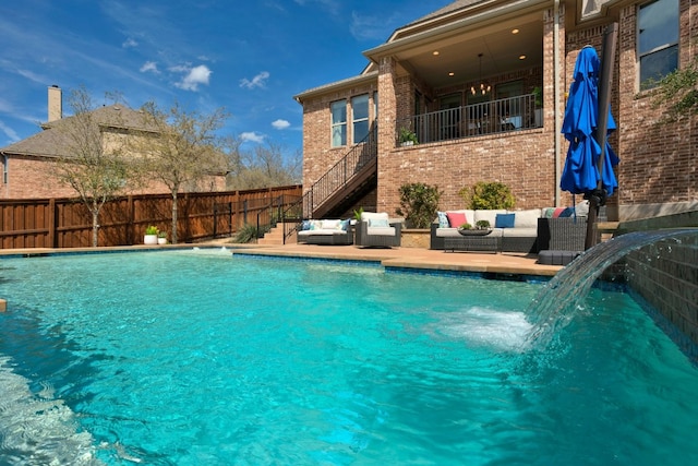 view of pool with cooling unit, outdoor lounge area, fence, stairway, and a fenced in pool