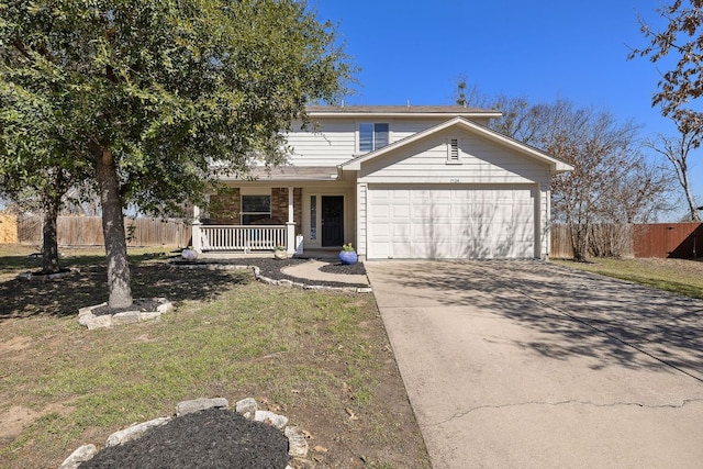 traditional home with a porch, an attached garage, fence, stone siding, and driveway