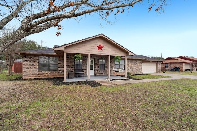 ranch-style house with a garage, brick siding, driveway, and a front lawn