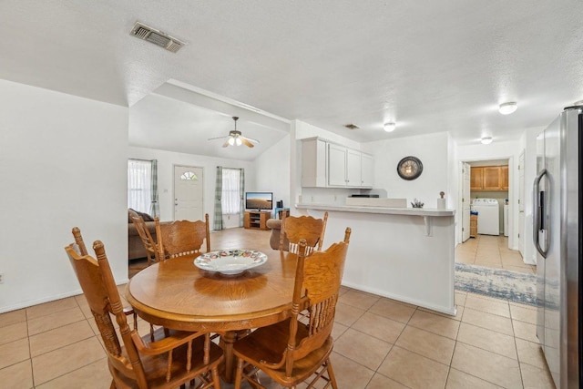 402 Laurel St, Bastrop, TX 78602 - dining room featuring washer / dryer, light tile patterned flooring, a textured ceiling, and a ceiling fan
