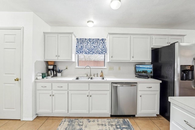 402 Laurel St, Bastrop, TX 78602 - kitchen with stainless steel appliances, light tile patterned floors, light countertops, and white cabinets