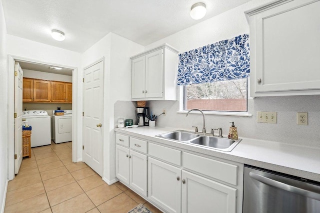 402 Laurel St, Bastrop, TX 78602 - kitchen featuring stainless steel dishwasher, a sink, separate washer and dryer, light tile patterned floors, and light countertops