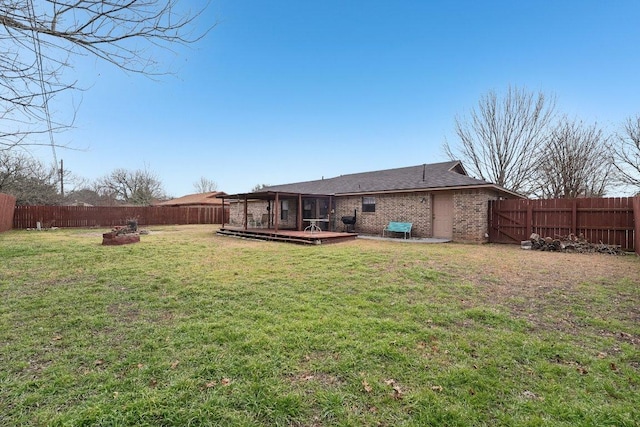 402 Laurel St, Bastrop, TX 78602 - rear view of property with a fenced backyard, a wooden deck, and brick siding