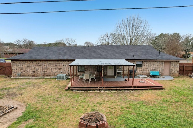 402 Laurel St, Bastrop, TX 78602 - back of house featuring an outdoor fire pit, brick siding, and a wooden deck