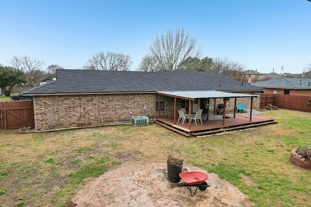 402 Laurel St, Bastrop, TX 78602 - back of house featuring a fenced backyard, a wooden deck, and brick siding