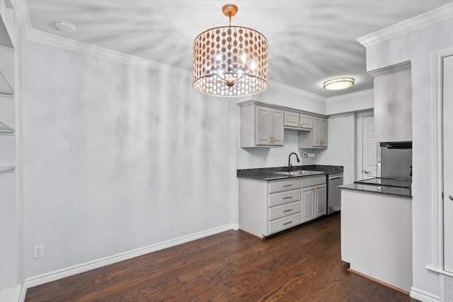 kitchen with dark countertops, dark wood-style floors, crown molding, gray cabinetry, and a sink