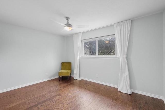 interior space featuring ceiling fan, wood finished floors, and baseboards