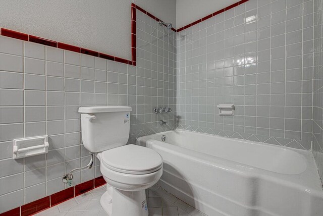 7803 Lazy Ln, Austin, TX 78757 - bathroom with tile walls, tile patterned floors, and toilet