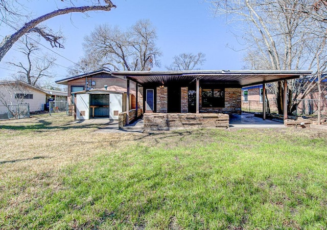 7803 Lazy Ln, Austin, TX 78757 - back of house featuring fence, covered porch, a yard, and stone siding