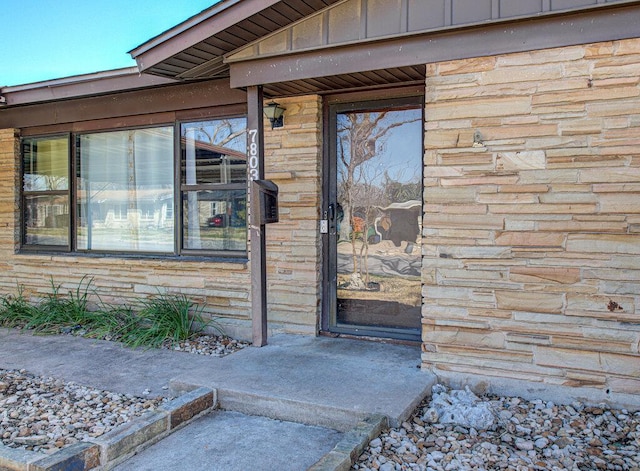 7803 Lazy Ln, Austin, TX 78757 - view of exterior entry featuring board and batten siding and stone siding