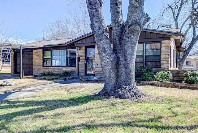 7803 Lazy Ln, Austin, TX 78757 - view of front facade with board and batten siding, a front yard, and stone siding