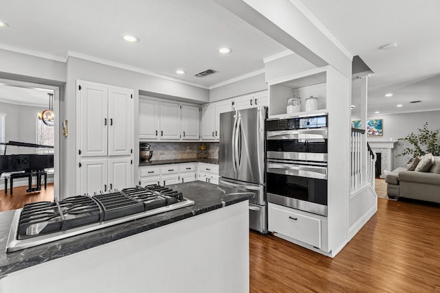 kitchen featuring appliances with stainless steel finishes, visible vents, dark wood-style floors, and open shelves