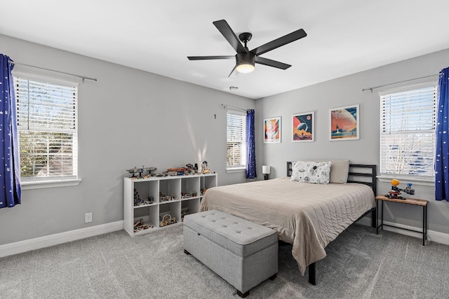 bedroom featuring carpet floors, ceiling fan, multiple windows, and baseboards