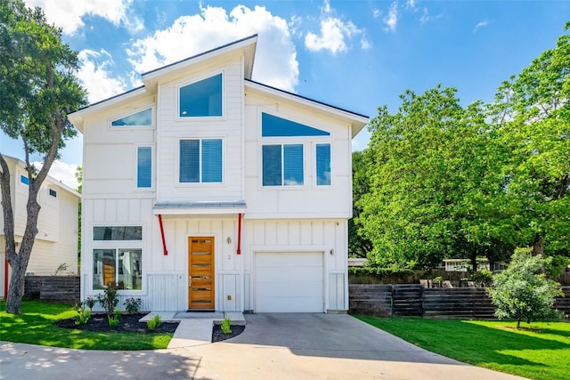 contemporary house with board and batten siding, concrete driveway, an attached garage, and a front lawn