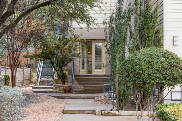 view of exterior entry with fence