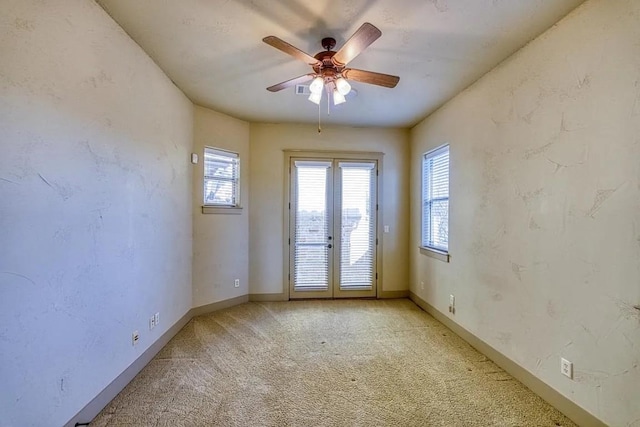 102 Maravilla Way, Horseshoe Bay, TX 78657 - spare room featuring plenty of natural light, ceiling fan, light colored carpet, and french doors