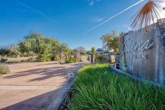 102 Maravilla Way, Horseshoe Bay, TX 78657 - view of concrete road with a gate and curbs