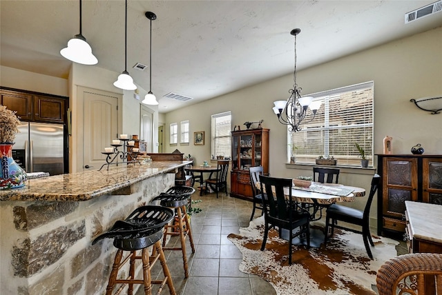 102 Maravilla Way, Horseshoe Bay, TX 78657 - dining area featuring a chandelier and tile patterned floors