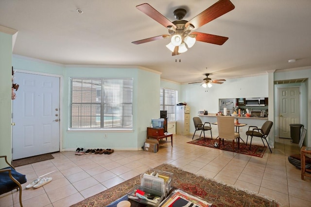 tiled living area with baseboards and crown molding