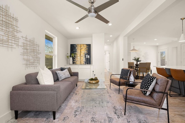 living room featuring baseboards, a ceiling fan, and recessed lighting