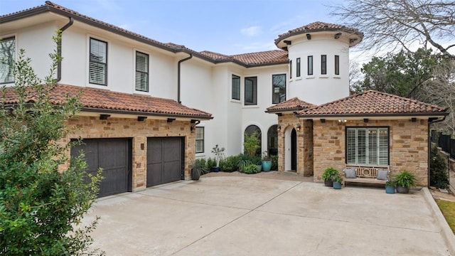 mediterranean / spanish home featuring a tile roof, stucco siding, an attached garage, stone siding, and driveway