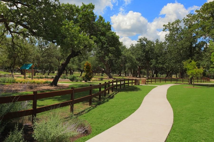 surrounding community with a lawn and fence