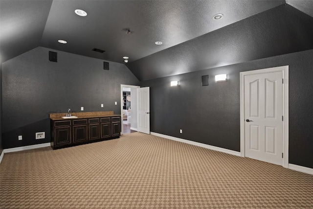 30302 Berry Creek Dr, Georgetown, TX 78628 - cinema room with a sink, baseboards, light colored carpet, lofted ceiling, and recessed lighting