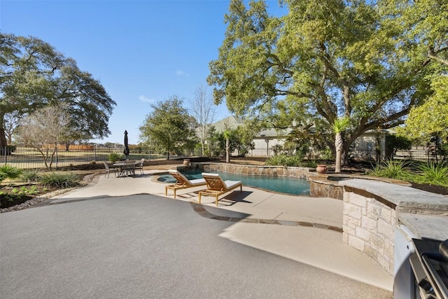 view of swimming pool with a patio, fence, and a fenced in pool