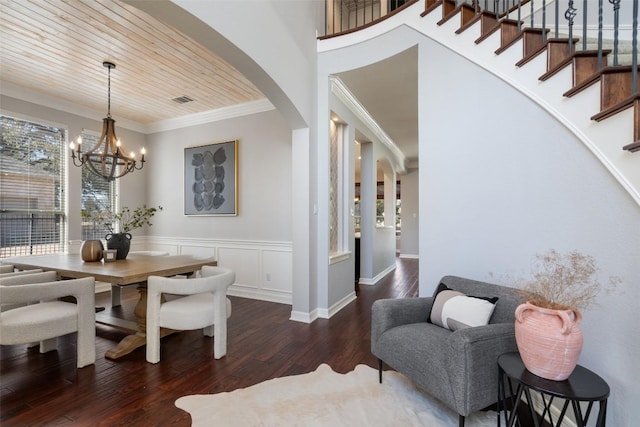 30302 Berry Creek Dr, Georgetown, TX 78628 - dining room with arched walkways, wainscoting, a chandelier, wood finished floors, and ornamental molding