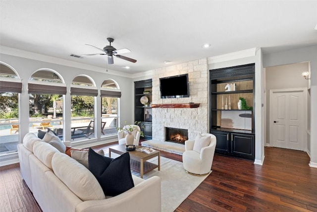 30302 Berry Creek Dr, Georgetown, TX 78628 - living area with a stone fireplace, a ceiling fan, hardwood / wood-style floors, and visible vents
