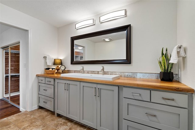 bathroom featuring vanity and a textured ceiling