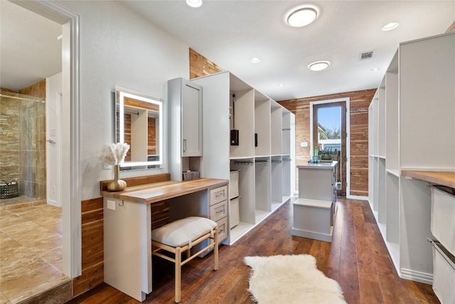 walk in closet featuring visible vents and wood finished floors