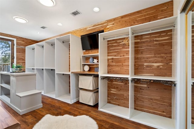 walk in closet with visible vents and dark wood finished floors