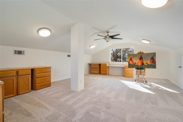 additional living space featuring light carpet, baseboards, visible vents, and vaulted ceiling