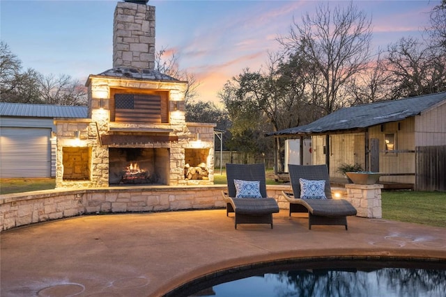 view of patio featuring an outdoor pool, an outdoor stone fireplace, and fence