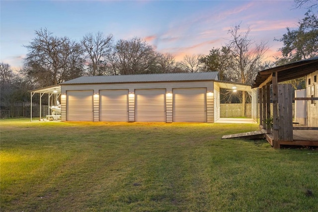 exterior space with a garage, an outdoor structure, and fence